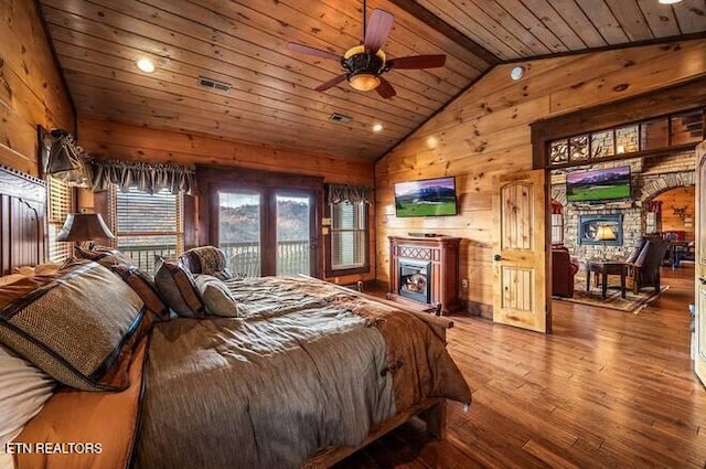 bedroom with wood-type flooring, lofted ceiling, wooden walls, and wood ceiling