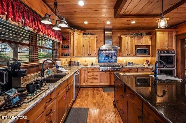 kitchen featuring stainless steel appliances, sink, wall chimney range hood, decorative light fixtures, and wooden ceiling