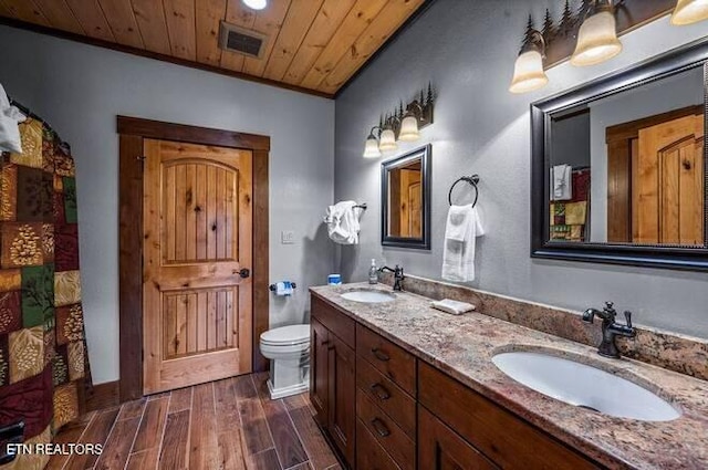 bathroom featuring vanity, toilet, wooden ceiling, and crown molding