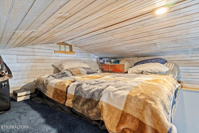 bedroom featuring wooden walls, vaulted ceiling, and wooden ceiling