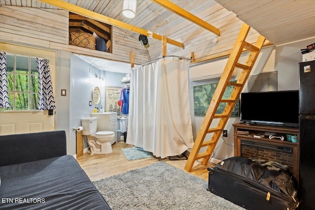 bedroom featuring wooden ceiling, connected bathroom, high vaulted ceiling, and hardwood / wood-style flooring