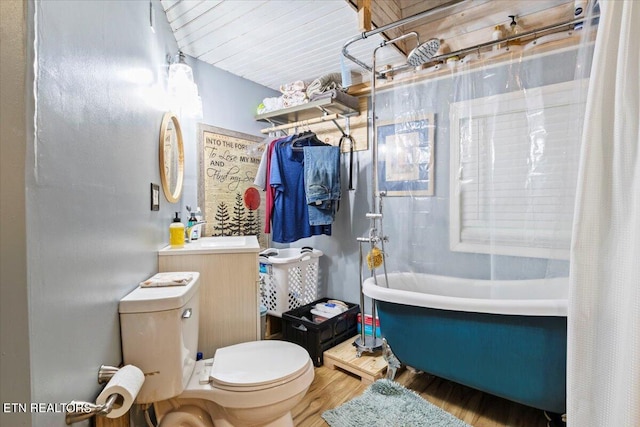 full bathroom featuring hardwood / wood-style floors, vanity, toilet, and shower / bathtub combination with curtain