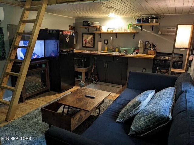 living room with light hardwood / wood-style floors, wooden ceiling, and a wall mounted air conditioner