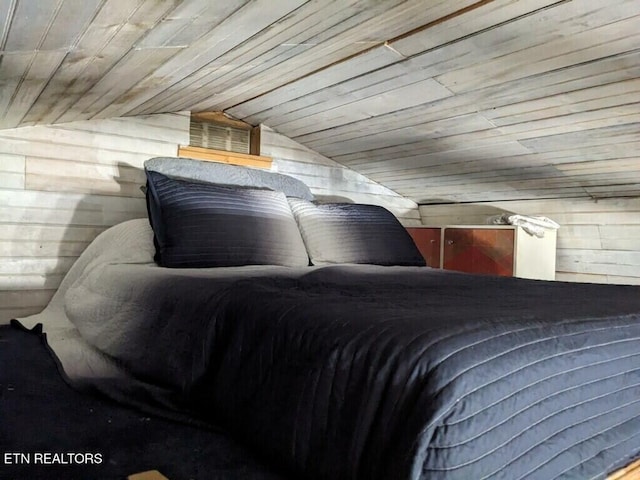 bedroom featuring wood ceiling, vaulted ceiling, and wood walls