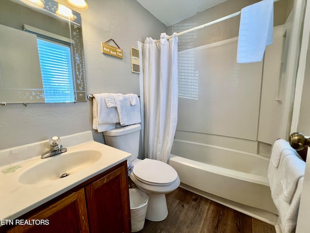 full bathroom featuring shower / bath combination with curtain, vanity, lofted ceiling, hardwood / wood-style flooring, and toilet