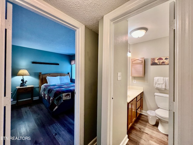 bedroom featuring a textured ceiling and hardwood / wood-style floors