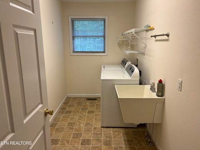 laundry room with washing machine and dryer and sink