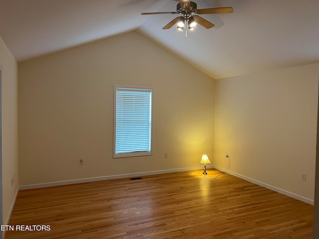 empty room with light hardwood / wood-style floors, ceiling fan, and lofted ceiling