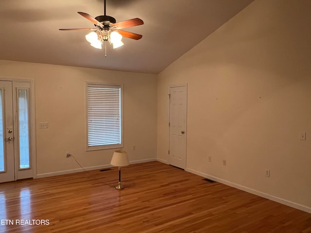 entryway with lofted ceiling, hardwood / wood-style flooring, ceiling fan, and plenty of natural light