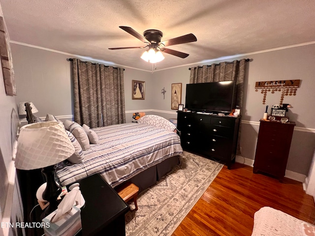 bedroom with ornamental molding, ceiling fan, and dark wood-type flooring