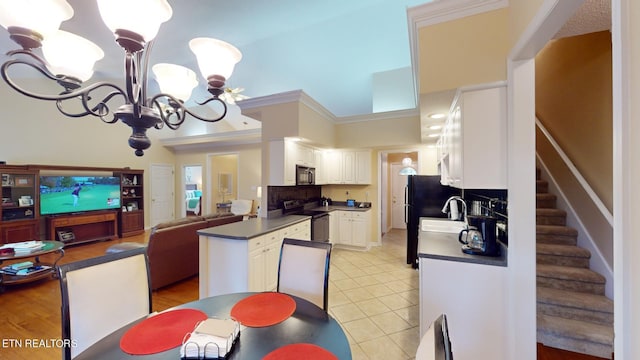 kitchen with ornamental molding, kitchen peninsula, white cabinetry, and stainless steel appliances