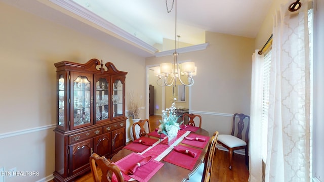 dining space with lofted ceiling, a chandelier, and dark wood-type flooring