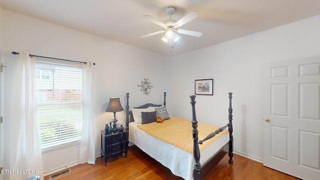 bedroom with wood-type flooring and ceiling fan