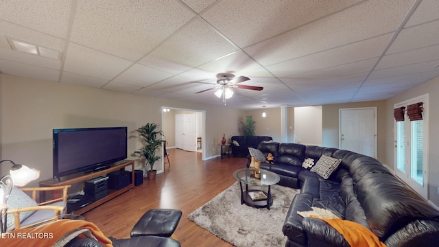 living room featuring ceiling fan, a paneled ceiling, and dark wood-type flooring