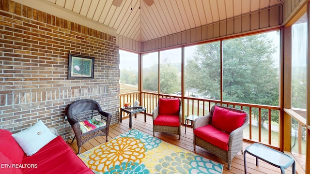 sunroom / solarium with ceiling fan, lofted ceiling, and wooden ceiling