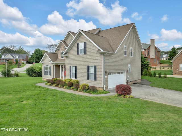 view of front of property featuring a garage and a front lawn