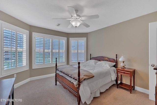 bedroom with ceiling fan and light colored carpet