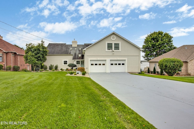 view of front property featuring a garage and a front lawn