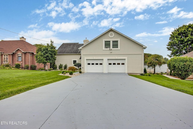 view of front of house with a garage and a front lawn