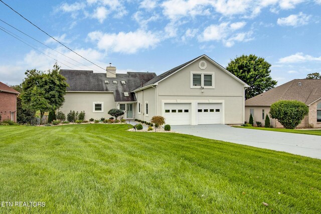 view of front facade featuring a garage and a front lawn