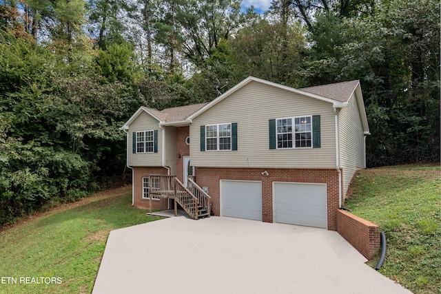 bi-level home featuring a front yard and a garage