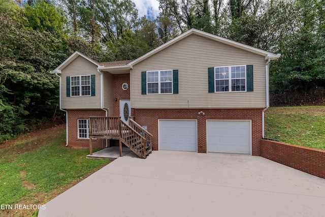 raised ranch with a garage and a front lawn