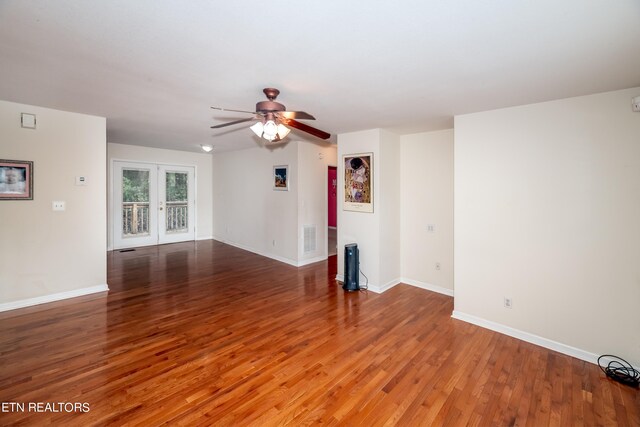 unfurnished living room featuring wood-type flooring and ceiling fan