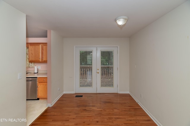 unfurnished dining area with french doors and light hardwood / wood-style flooring