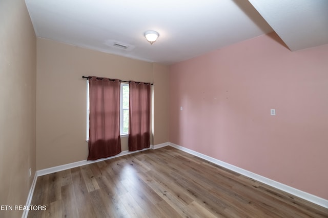 unfurnished room with light hardwood / wood-style floors