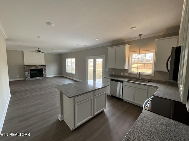 kitchen with dark hardwood / wood-style floors, pendant lighting, white cabinetry, sink, and stainless steel dishwasher