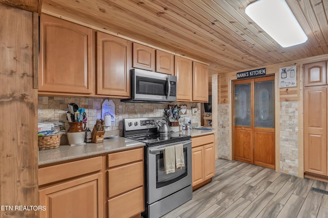 kitchen with appliances with stainless steel finishes, backsplash, light hardwood / wood-style floors, and wood ceiling