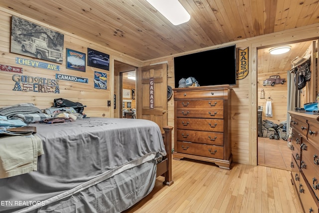 bedroom featuring wood ceiling, wood walls, and light hardwood / wood-style floors