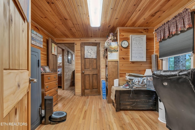 office area with light wood-type flooring, wood ceiling, and wooden walls