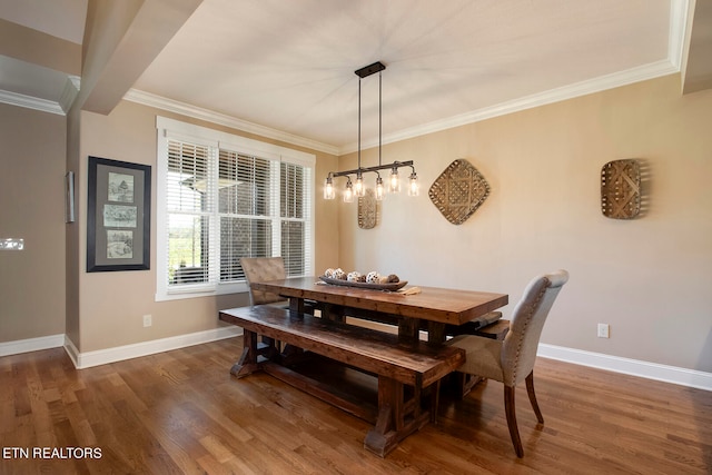 dining space with crown molding and dark hardwood / wood-style flooring