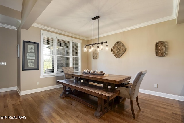 dining room with crown molding, dark wood-style flooring, and baseboards