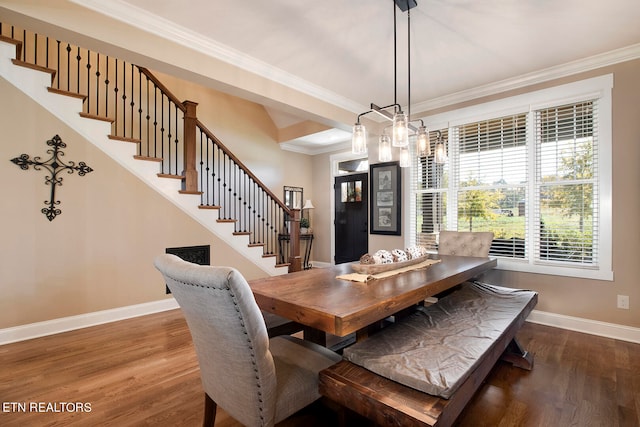 dining area featuring ornamental molding and dark wood-type flooring