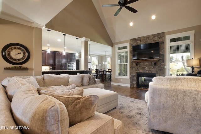 living area with a wealth of natural light, wood finished floors, a ceiling fan, and recessed lighting