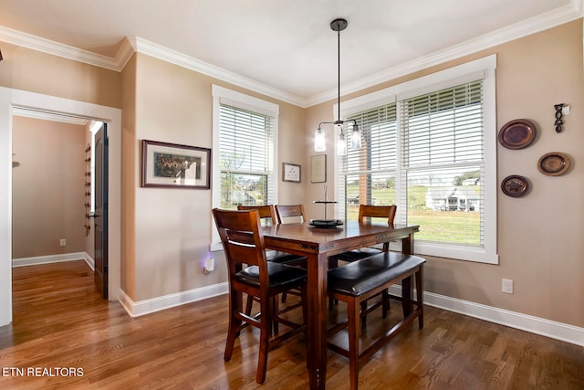 dining space featuring ornamental molding, plenty of natural light, and dark hardwood / wood-style flooring