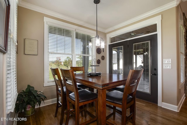 dining space featuring french doors, ornamental molding, baseboards, and dark wood-style floors