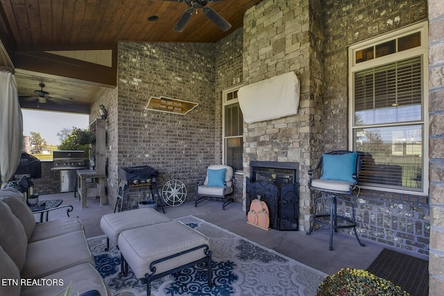 view of patio / terrace featuring ceiling fan, exterior kitchen, an outdoor hangout area, and a grill