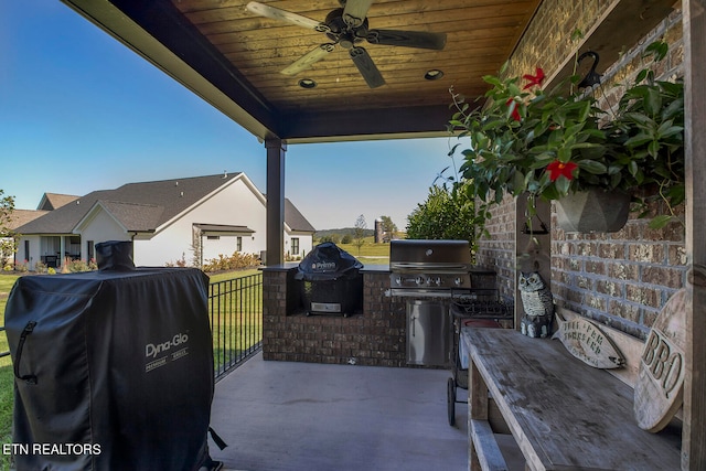 view of patio / terrace featuring a grill, an outdoor kitchen, and ceiling fan