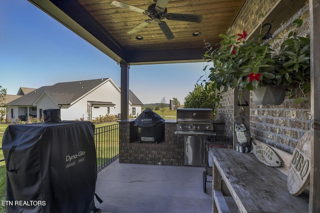 view of patio featuring a ceiling fan, area for grilling, and a grill