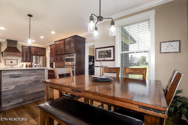 dining room with recessed lighting, ornamental molding, and dark wood finished floors