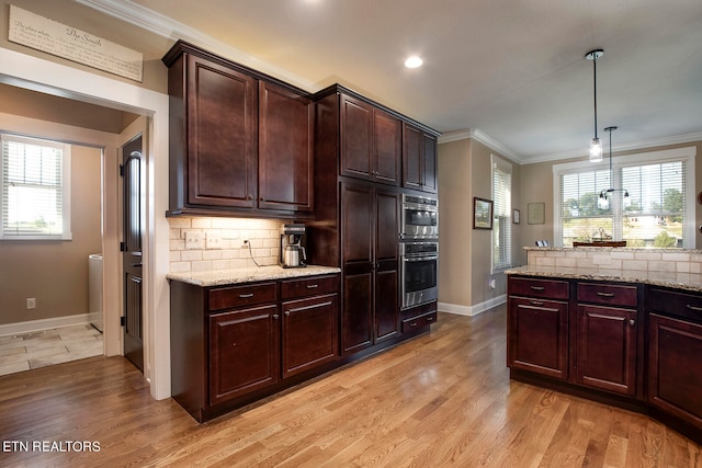 kitchen featuring ornamental molding, hanging light fixtures, plenty of natural light, and light hardwood / wood-style floors