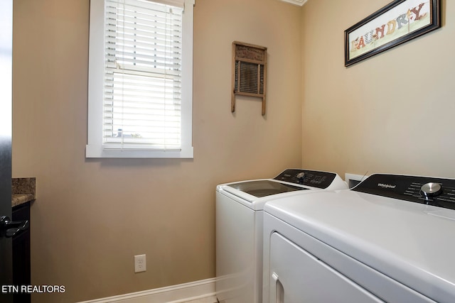 laundry area with washing machine and dryer and cabinets