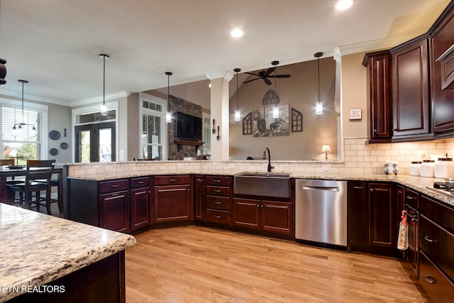 kitchen featuring hanging light fixtures, light wood-type flooring, stainless steel dishwasher, and ceiling fan