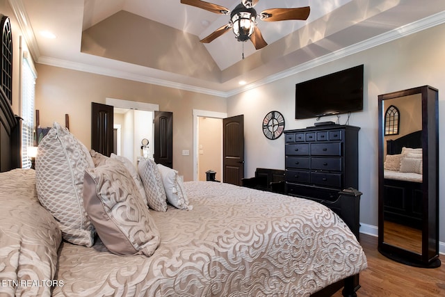 bedroom with lofted ceiling, crown molding, ceiling fan, and hardwood / wood-style floors