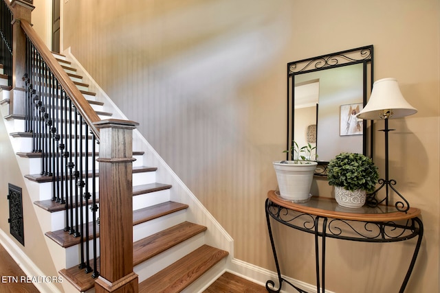 stairway featuring wood-type flooring