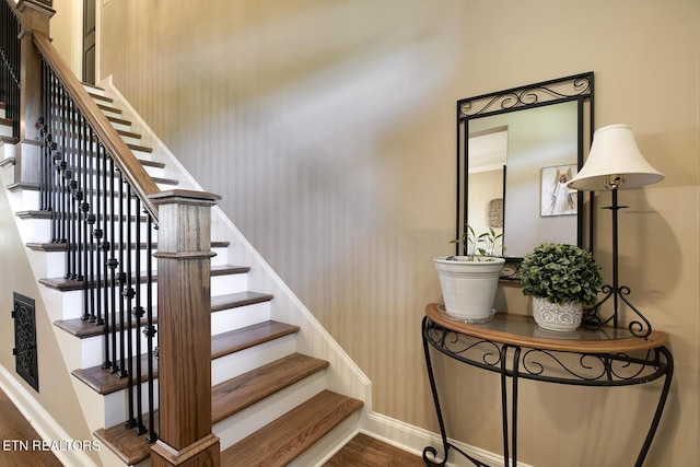 stairs featuring baseboards and wood finished floors