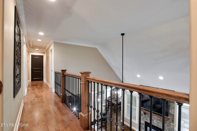 corridor featuring crown molding and light hardwood / wood-style flooring